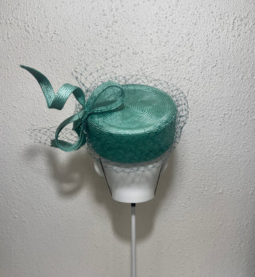 Twisted teal pillbox