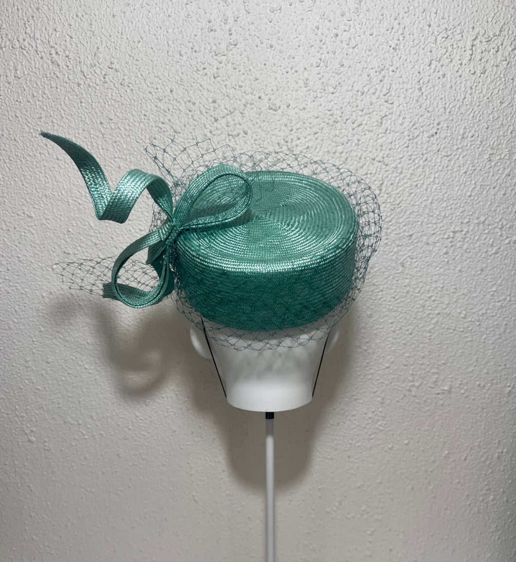 Twisted teal pillbox