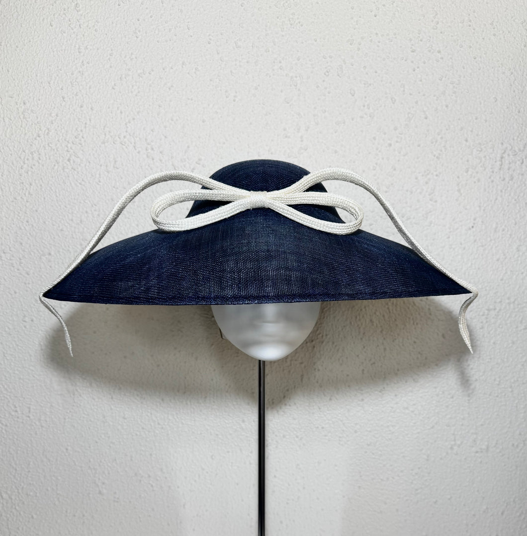 Coolie in navy with upside down bow