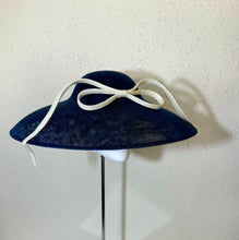 Coolie in navy with upside down bow