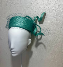 Twisted teal pillbox